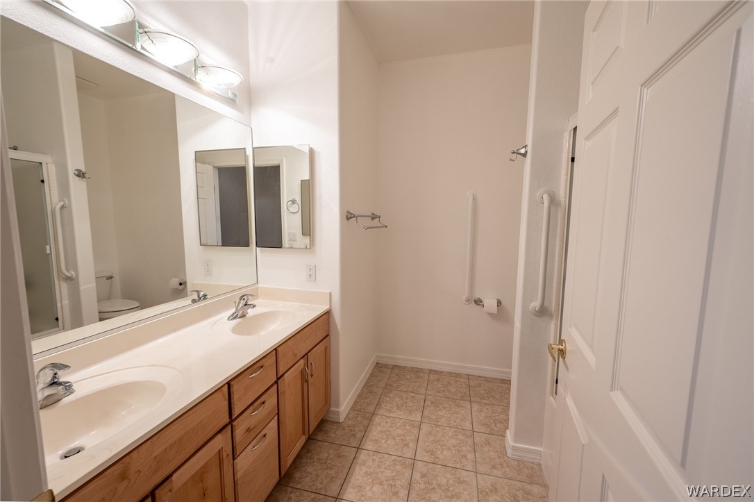 5762 Ruth Drive Fort Mohave, AZ 86426 - Photo 11 of 29 a bathroom with a double vanity sink and a mirror