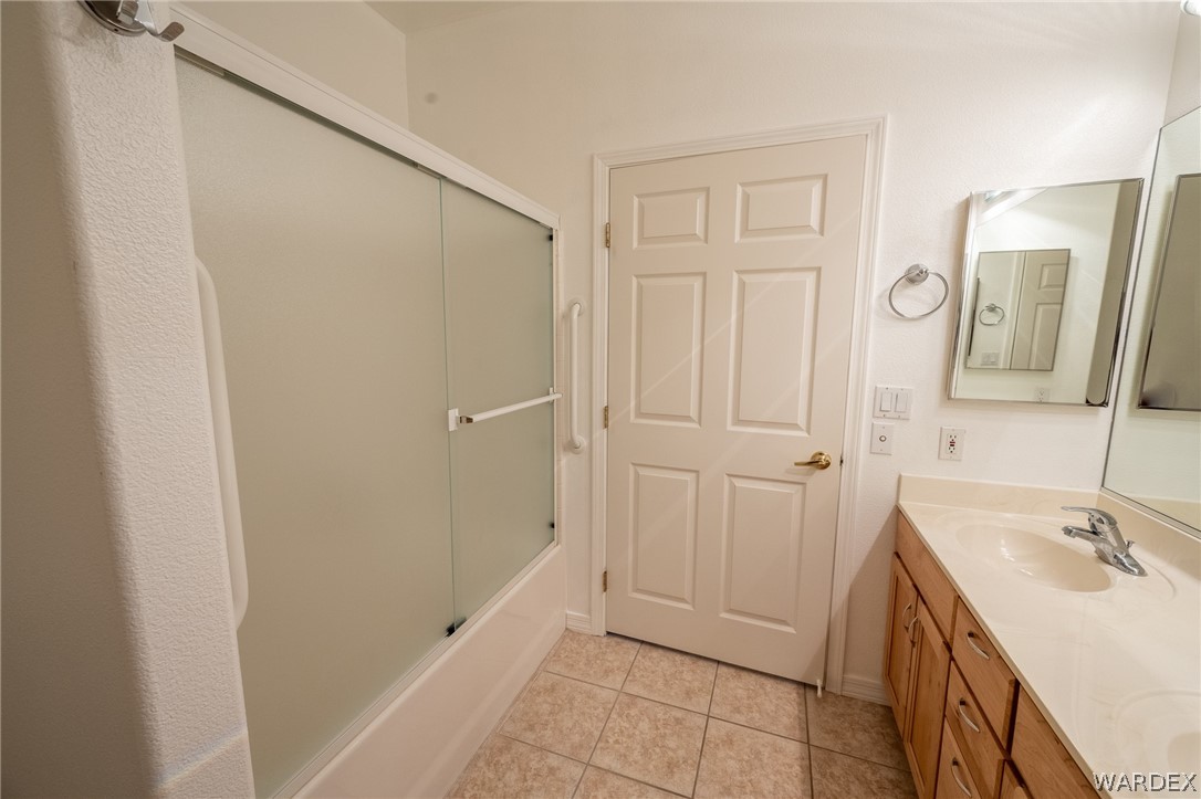 5762 Ruth Drive Fort Mohave, AZ 86426 - Photo 12 of 29 a bathroom with a sink a mirror and a shower