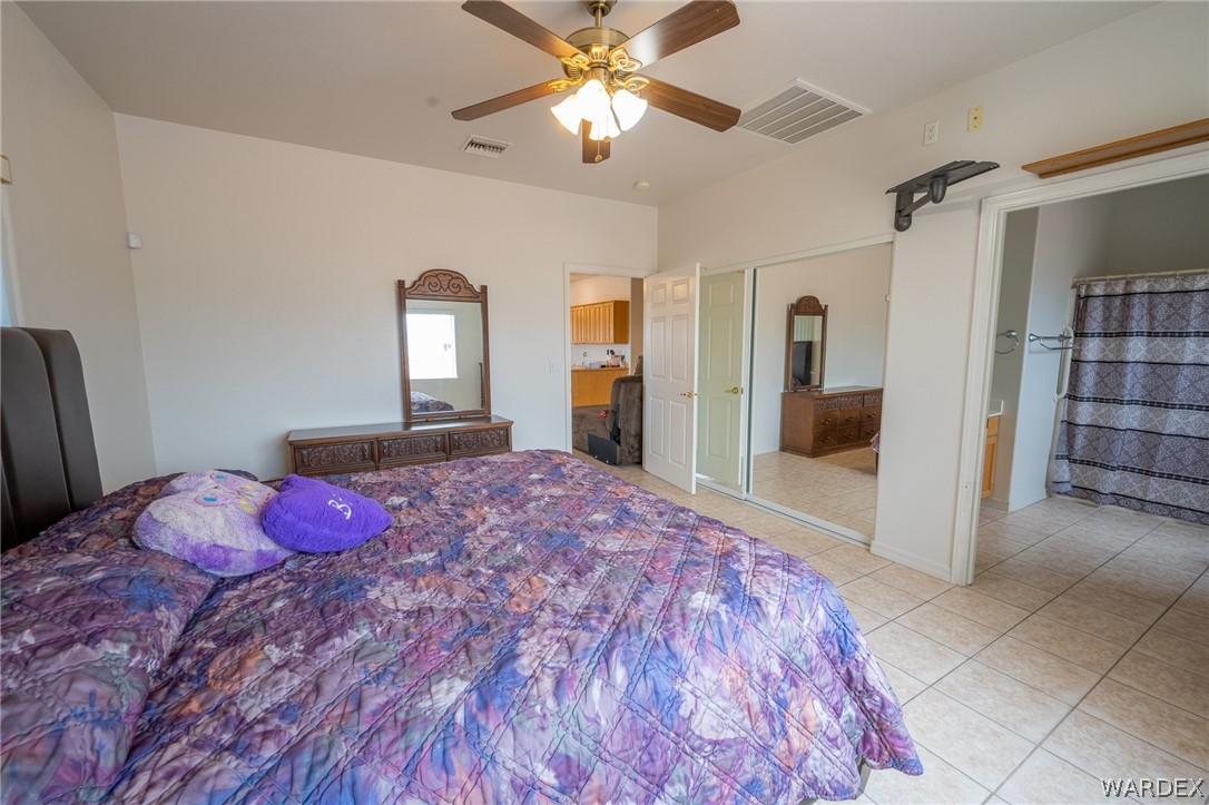 5762 Ruth Drive Fort Mohave, AZ 86426 - Photo 16 of 29 a bedroom with a bed and a chandelier