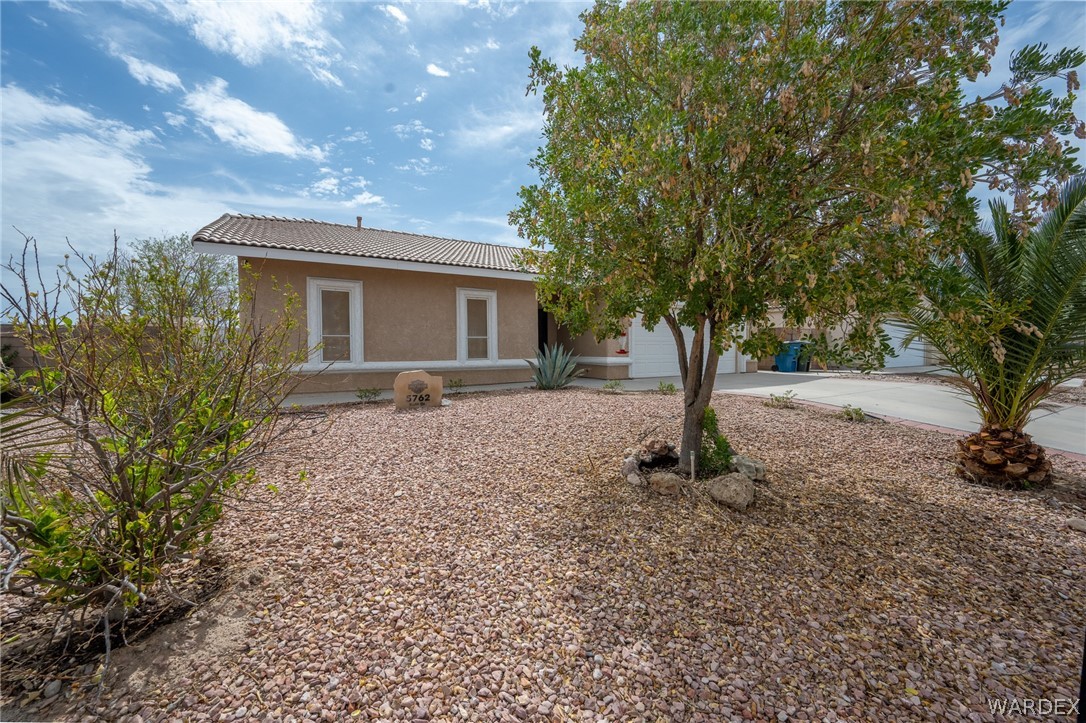 5762 Ruth Drive Fort Mohave, AZ 86426 - Photo 2 of 29 a front view of a house with garden