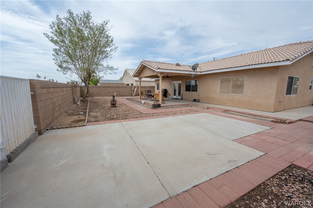 5762 Ruth Drive Fort Mohave, AZ 86426 - Photo 22 of 29 a backyard of a house with table and chairs