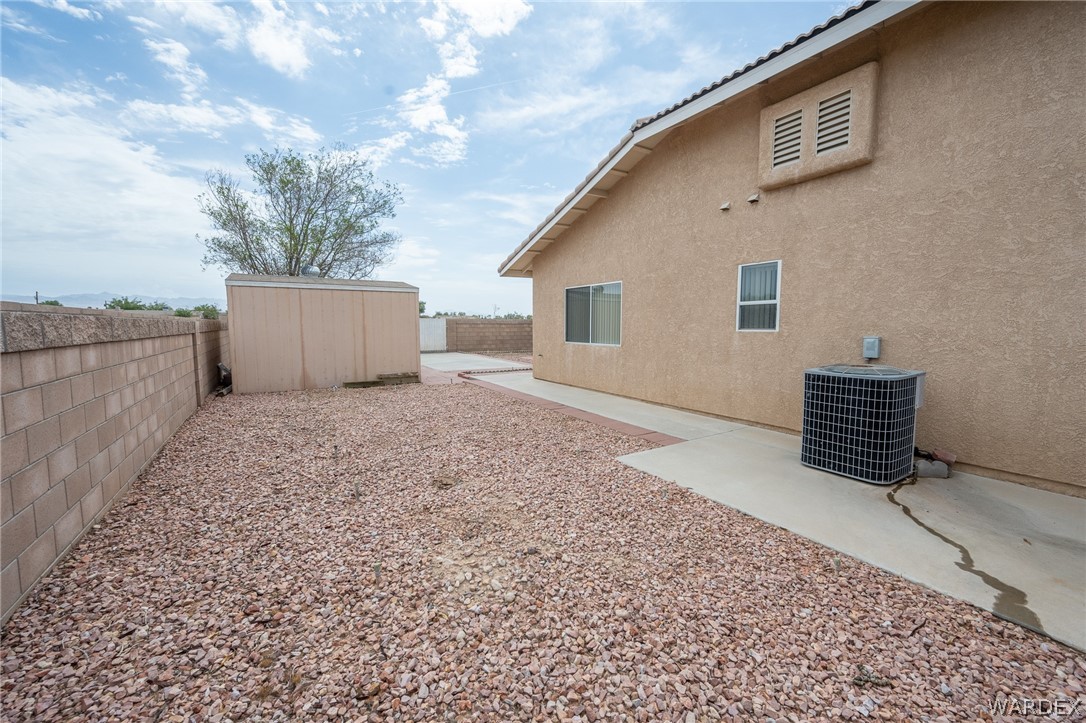 5762 Ruth Drive Fort Mohave, AZ 86426 - Photo 23 of 29 a view of backyard with barbeque grill and wooden fence