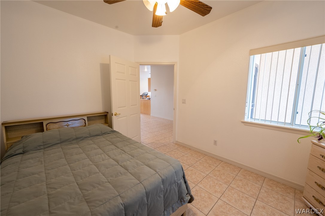 5762 Ruth Drive Fort Mohave, AZ 86426 - Photo 9 of 29 a bedroom with a bed and a chandelier