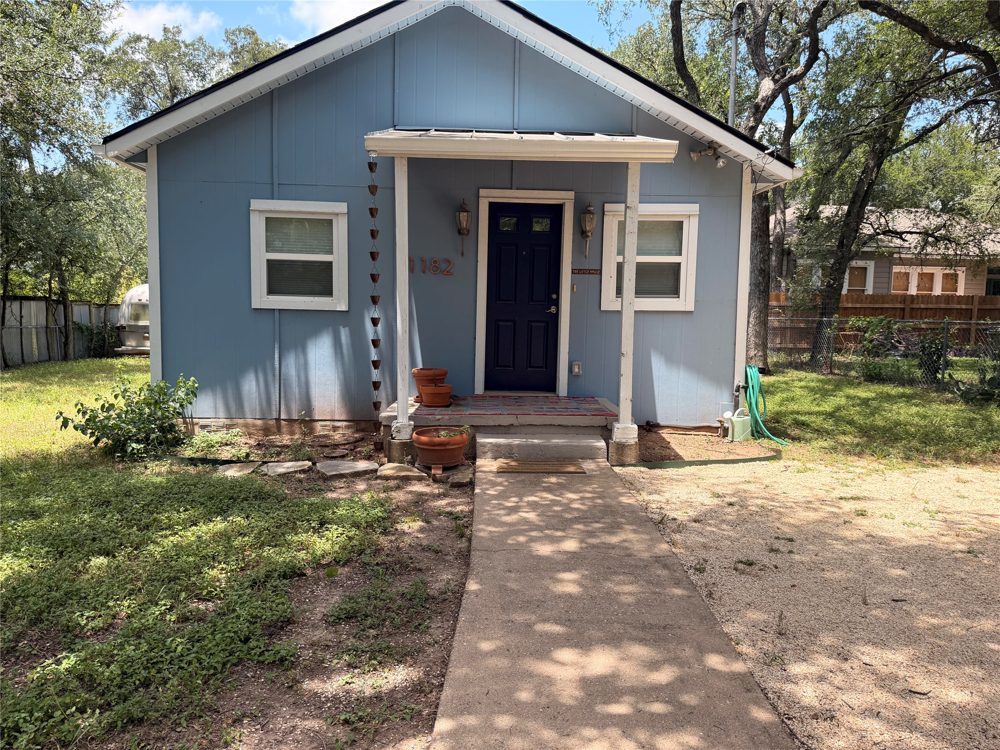 1182 Pandora Street Austin, TX 78702 - Photo 16 of 19 A welcoming path leads to a cozy home with a covered front porch.