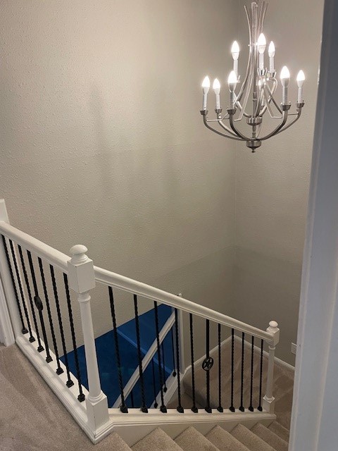 407 West Semands Street Conroe, TX 77301 - Photo 10 of 28 a view of staircase with railing and chandelier