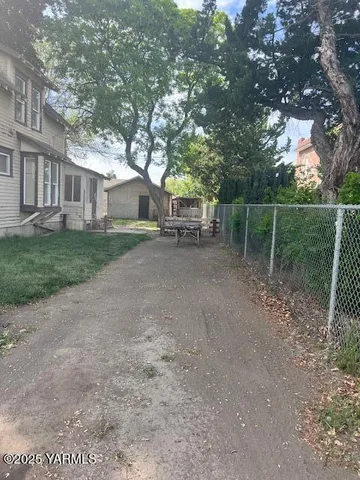 a backyard of a house with table and chairs