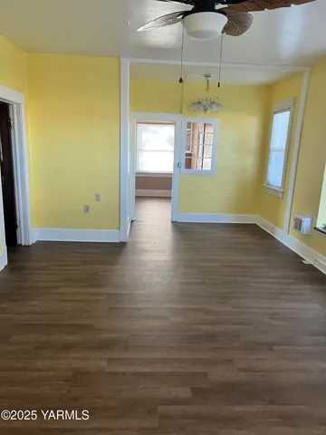 a view of a small space with wooden floor and a window