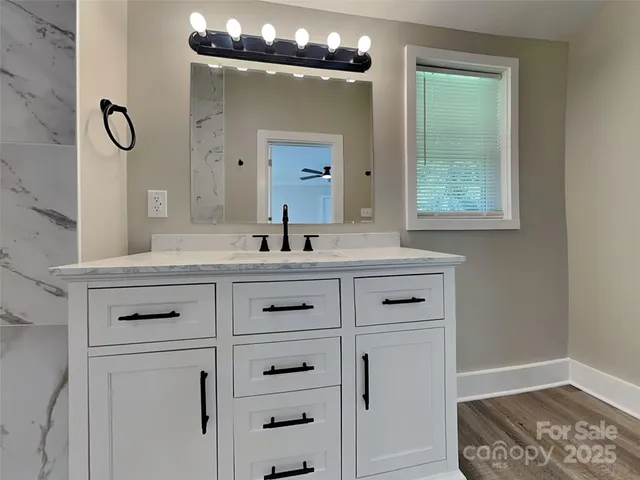 a bathroom with a sink vanity and a mirror