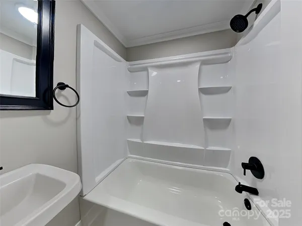 a bathroom with a tub and a shower