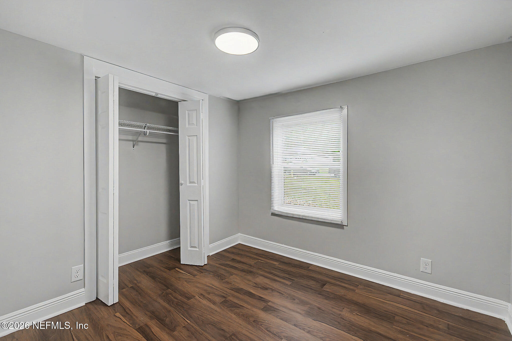 2625 Kohn Road Jacksonville, FL 32210 - Photo 16 of 34 an empty room with wooden floor and windows