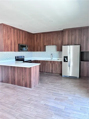 a view of a big room with wooden floor and a ceiling fan