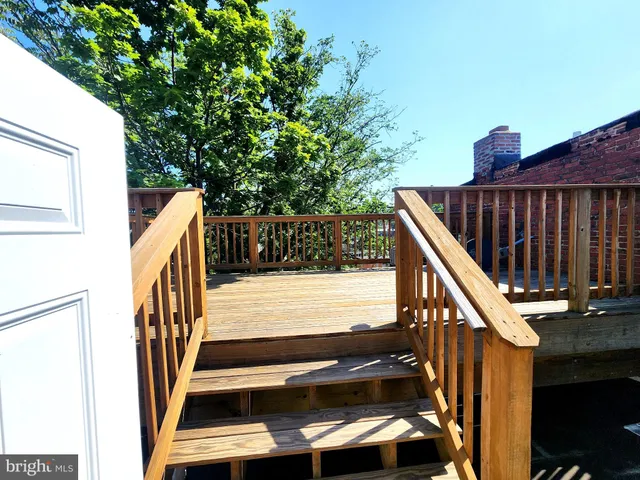 a view of balcony with wooden floor and fence