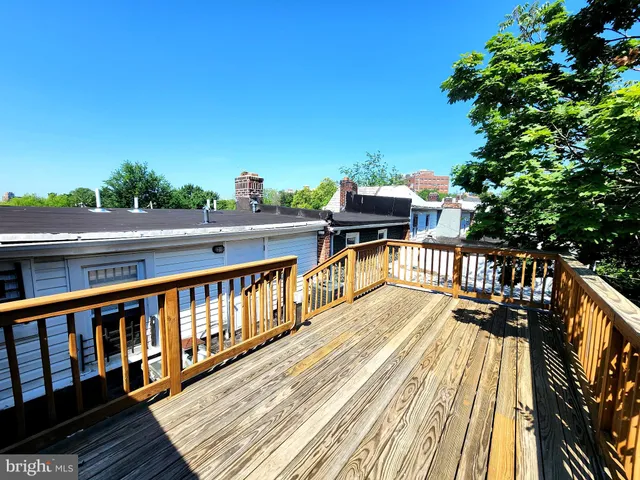 a view of balcony with wooden floor and fence