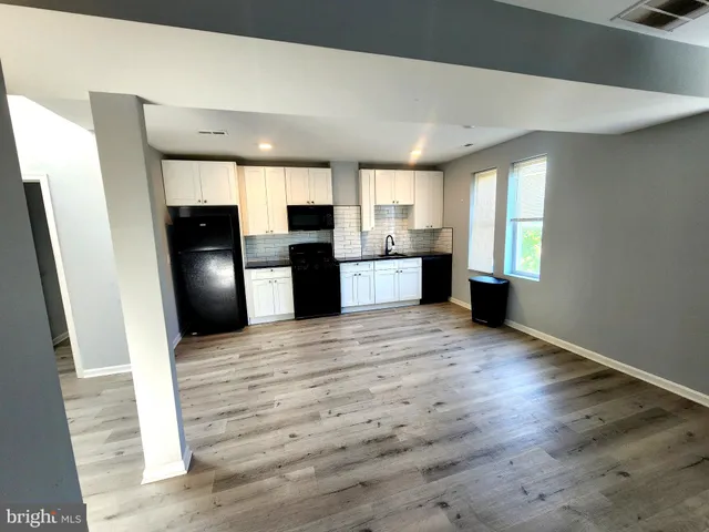 a view of kitchen with stainless steel appliances refrigerator microwave and stove