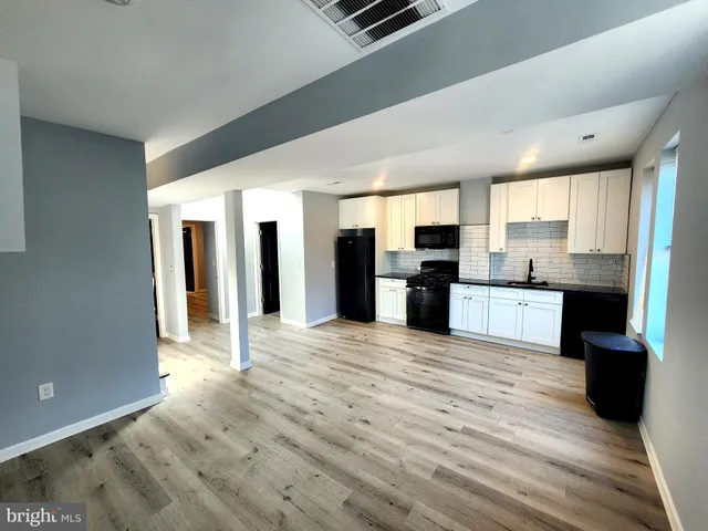 a view of a kitchen with a sink and a window