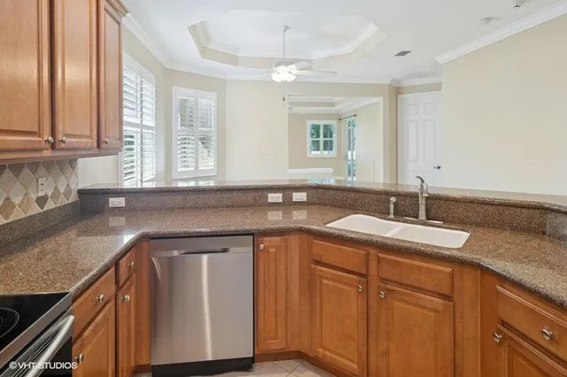 a kitchen with stainless steel appliances granite countertop a sink stove and microwave