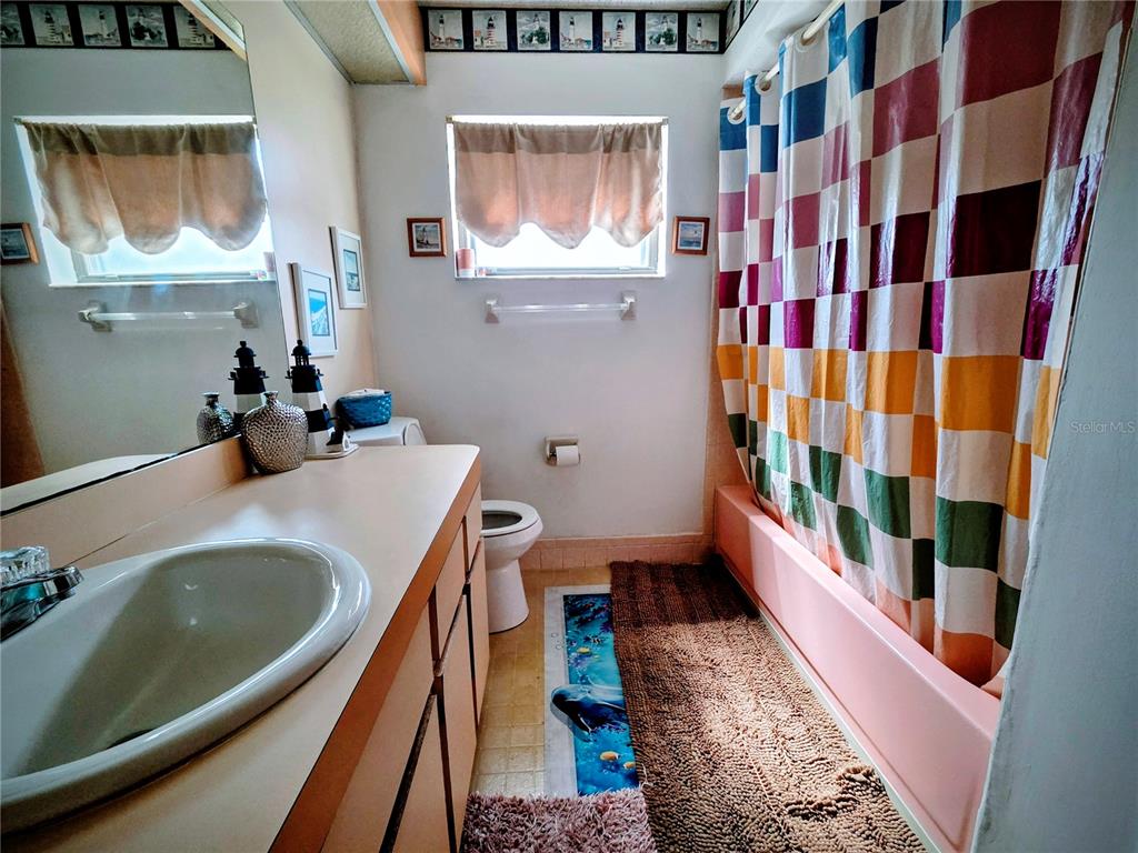 8026 Victoria Way Weeki Wachee, FL 34613 - Photo 11 of 18 a bathroom with a sink and a mirror