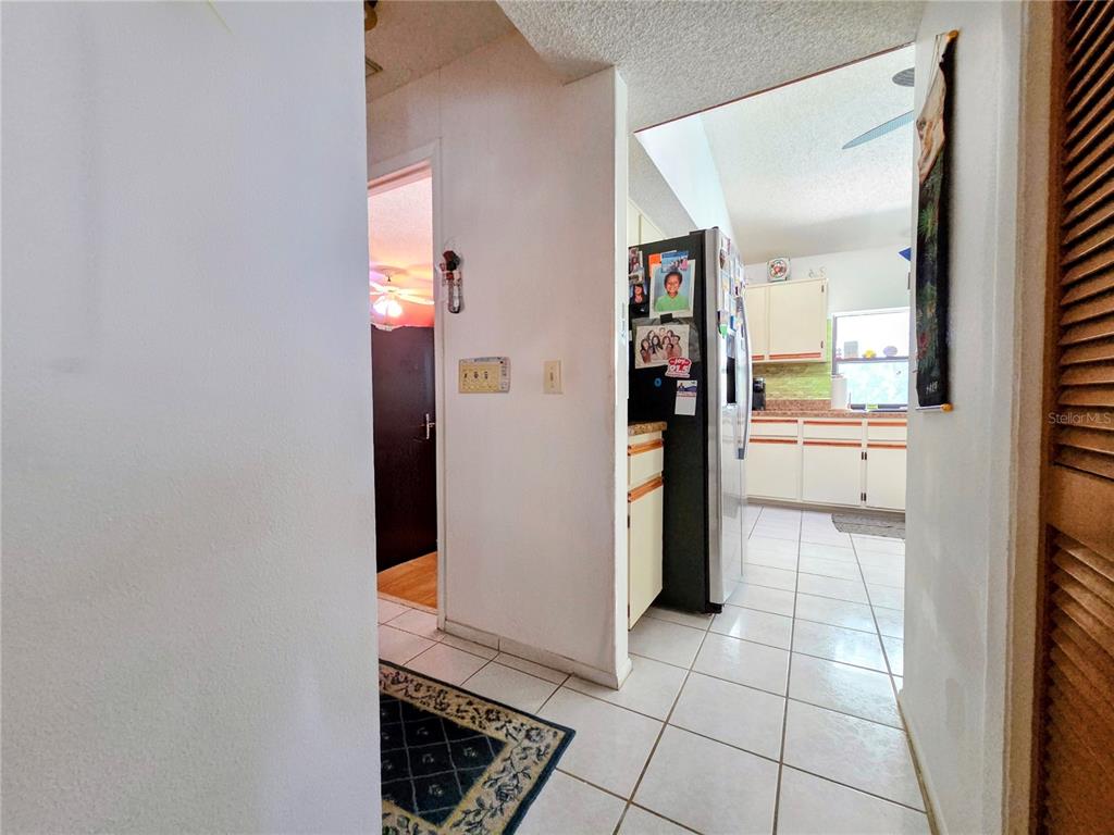 8026 Victoria Way Weeki Wachee, FL 34613 - Photo 13 of 18 a view of a living room with a refrigerator