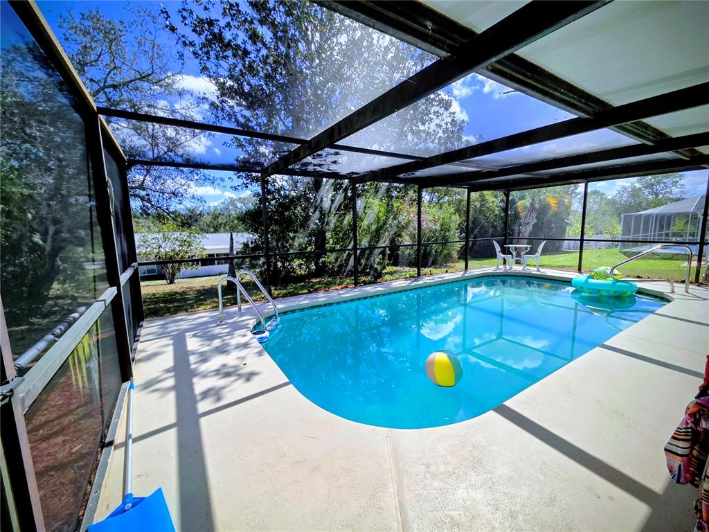8026 Victoria Way Weeki Wachee, FL 34613 - Photo 14 of 18 a view of a swimming pool with a patio