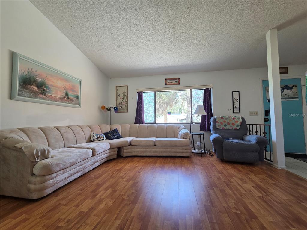 8026 Victoria Way Weeki Wachee, FL 34613 - Photo 3 of 18 a living room with furniture and a wooden floor