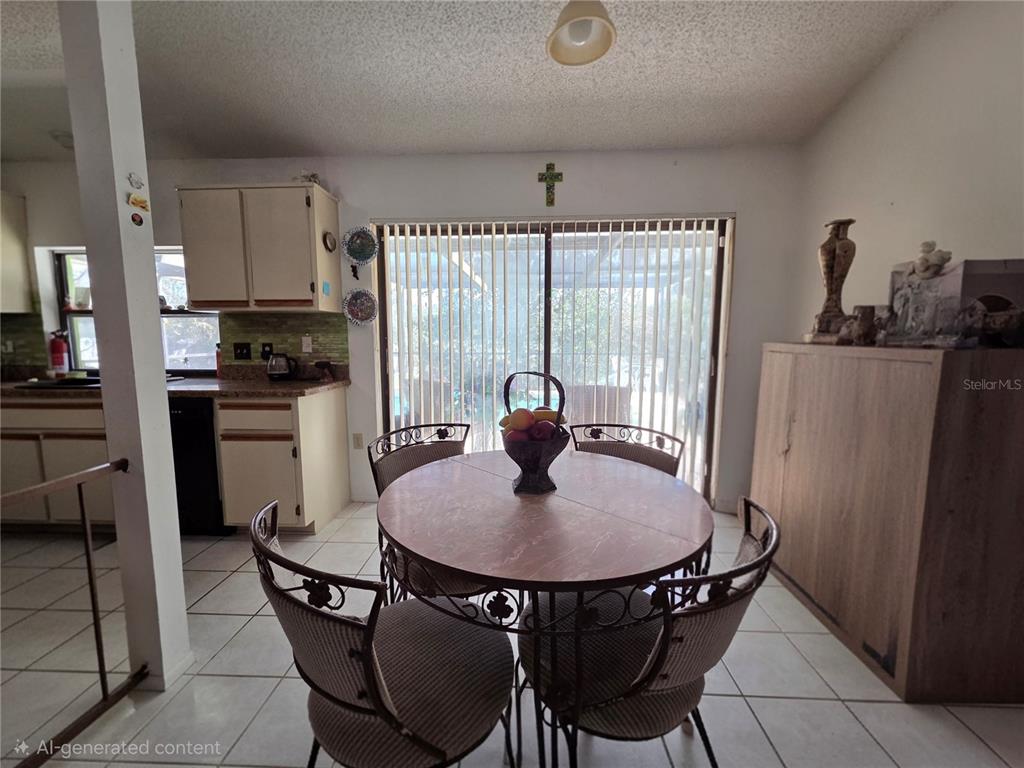 8026 Victoria Way Weeki Wachee, FL 34613 - Photo 5 of 18 a kitchen with stainless steel appliances granite countertop a dining table and chairs
