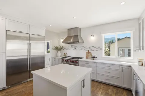 a kitchen with a sink stove and cabinets