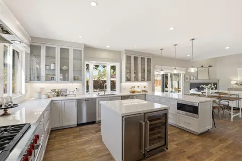 a living room with furniture a fireplace and a table