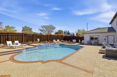a view of swimming pool with seating space and barbeque oven