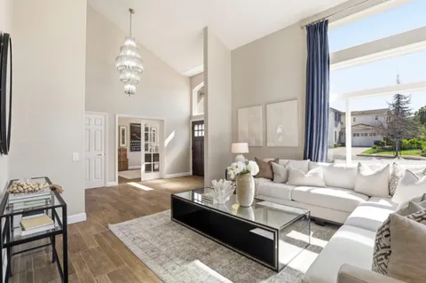 a living room with furniture a table and wooden floor