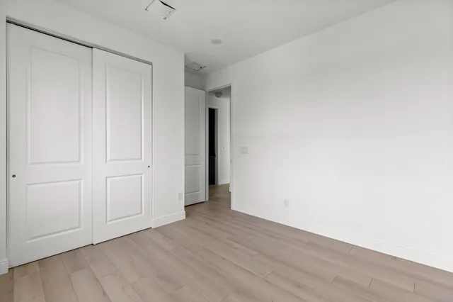 a view of an empty room and wooden floor