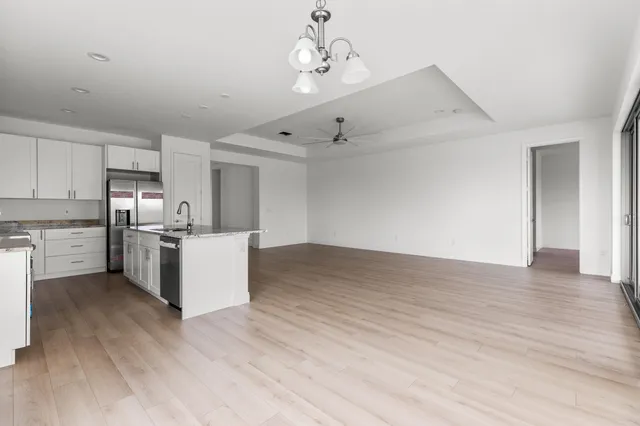 a view of kitchen with granite countertop cabinets and wooden floor