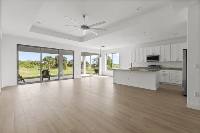 a view of a kitchen with wooden floor and a window