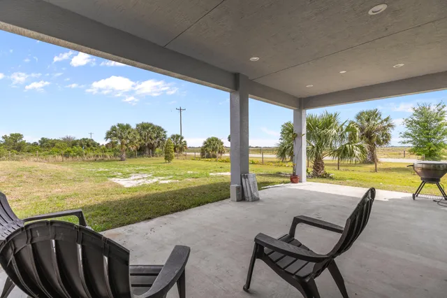 a view of a swimming pool with an outdoor seating