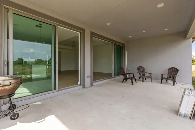a view of a room with gym equipment and large window