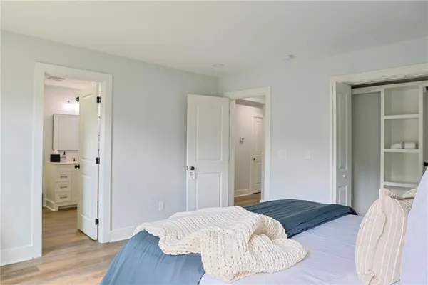 a bedroom with a bed and wooden floor