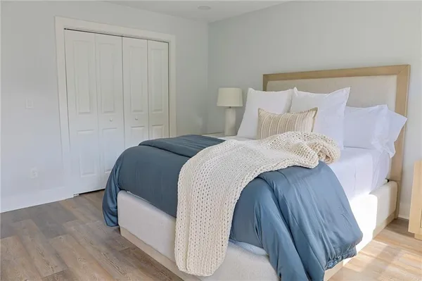 a bedroom with a bed and a mirror