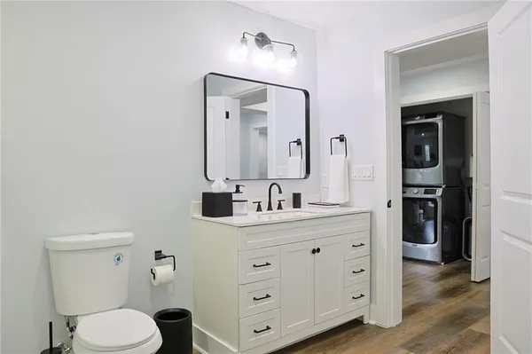 a bathroom with a toilet a sink a vanity and mirror