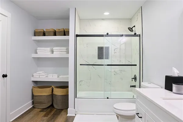 a bathroom with a sink a toilet and shower