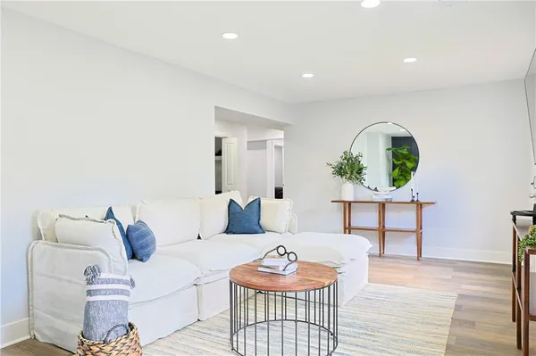a living room with furniture and a wooden floor