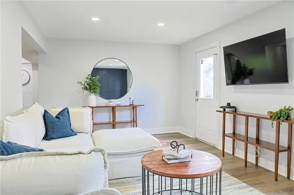a living room with furniture and a flat screen tv