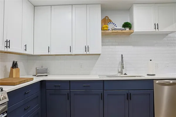 a kitchen with a sink and cabinets