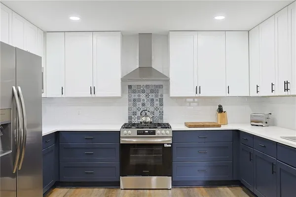 a kitchen with stainless steel appliances granite countertop a stove and a refrigerator