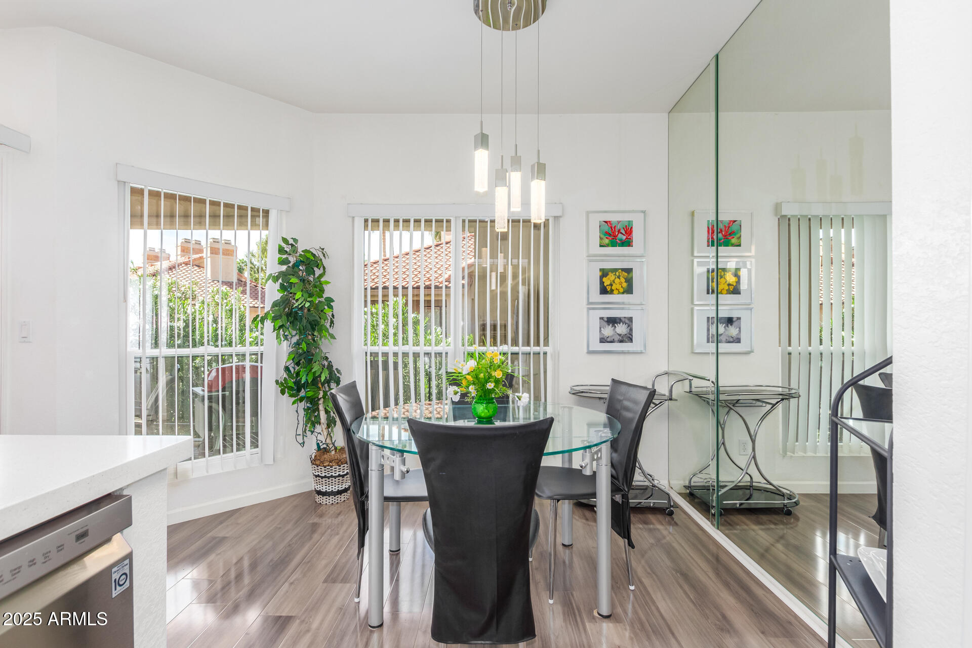 9711 East Mountain View Road, Unit 2524 Scottsdale, AZ 85258 - Photo 18 of 48 a dining room with furniture potted plants and wooden floor
