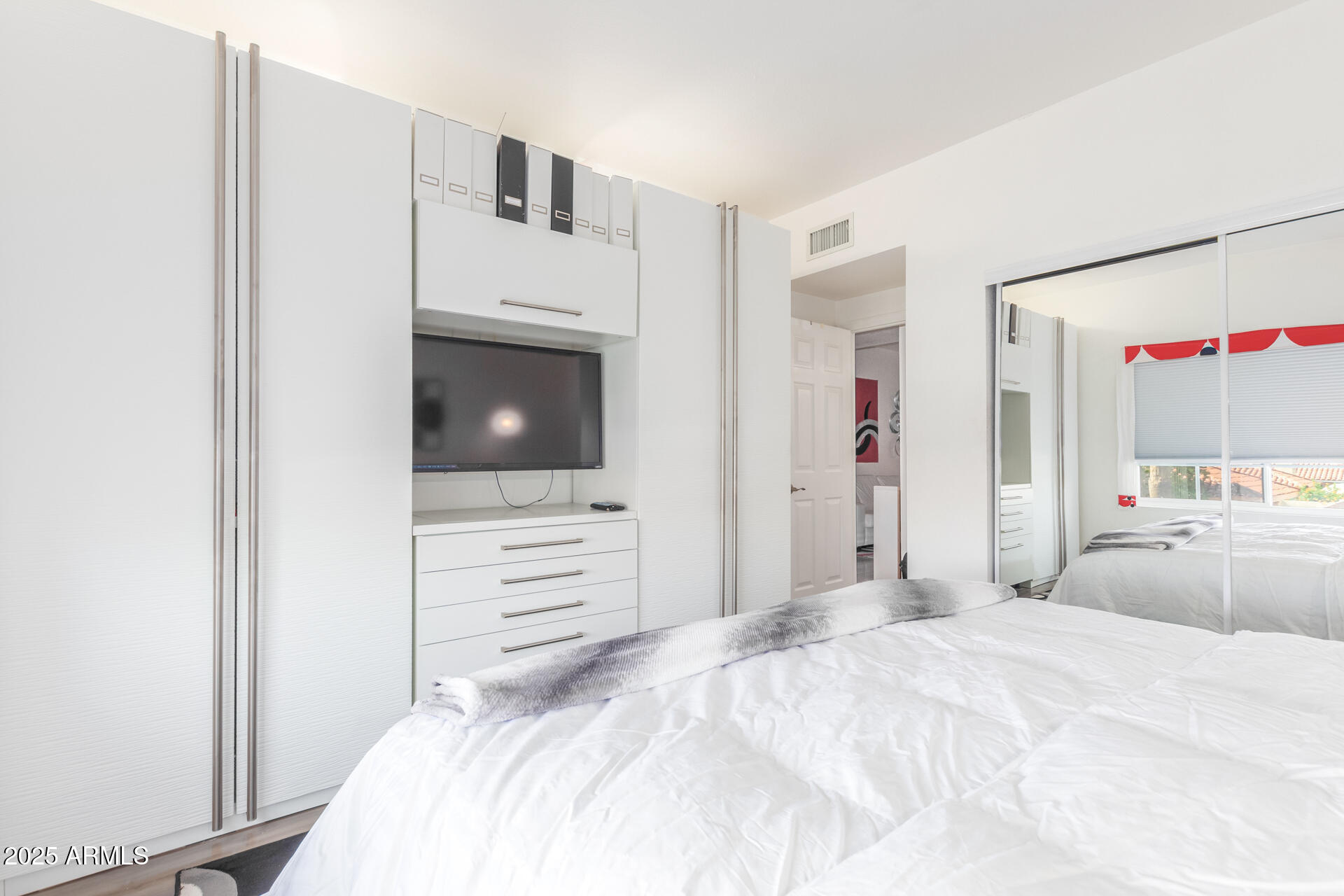 9711 East Mountain View Road, Unit 2524 Scottsdale, AZ 85258 - Photo 25 of 48 a bedroom with a bed and a flat screen tv