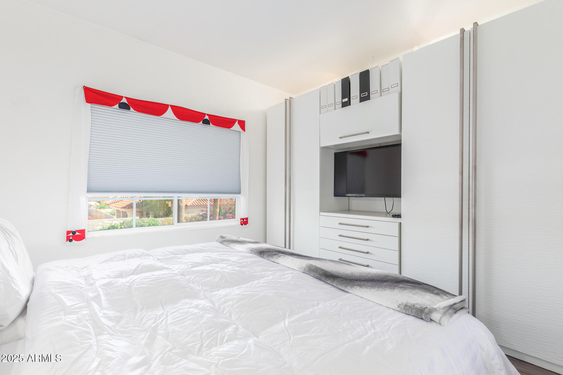 9711 East Mountain View Road, Unit 2524 Scottsdale, AZ 85258 - Photo 26 of 48 a view of a bedroom with a bed and a flat screen tv