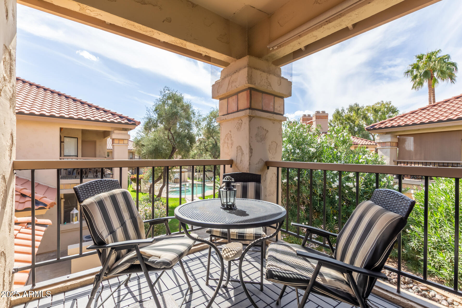 9711 East Mountain View Road, Unit 2524 Scottsdale, AZ 85258 - Photo 29 of 48 a balcony with wooden floor and outdoor seating