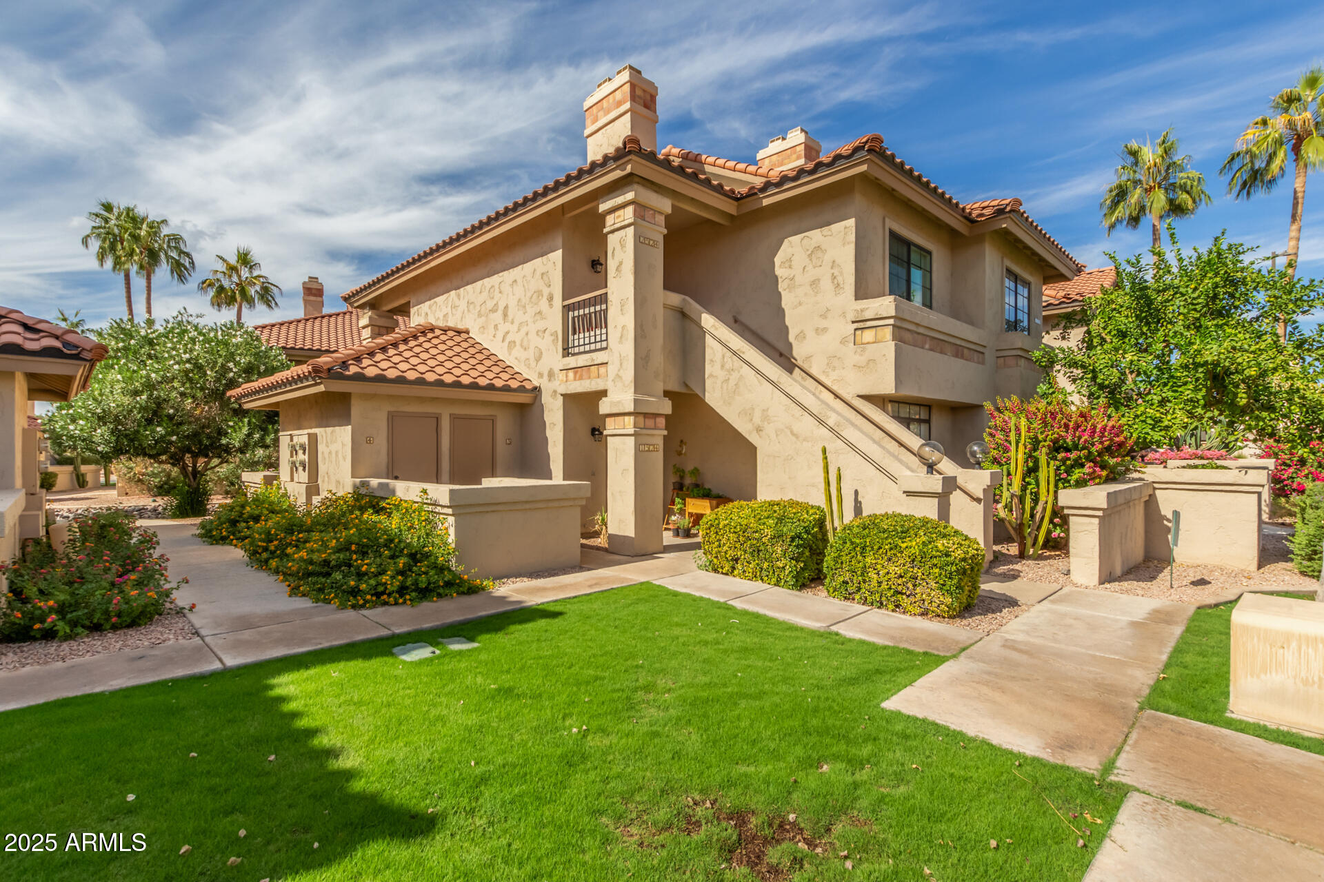 9711 East Mountain View Road, Unit 2524 Scottsdale, AZ 85258 - Photo 3 of 48 a front view of a house with a garden