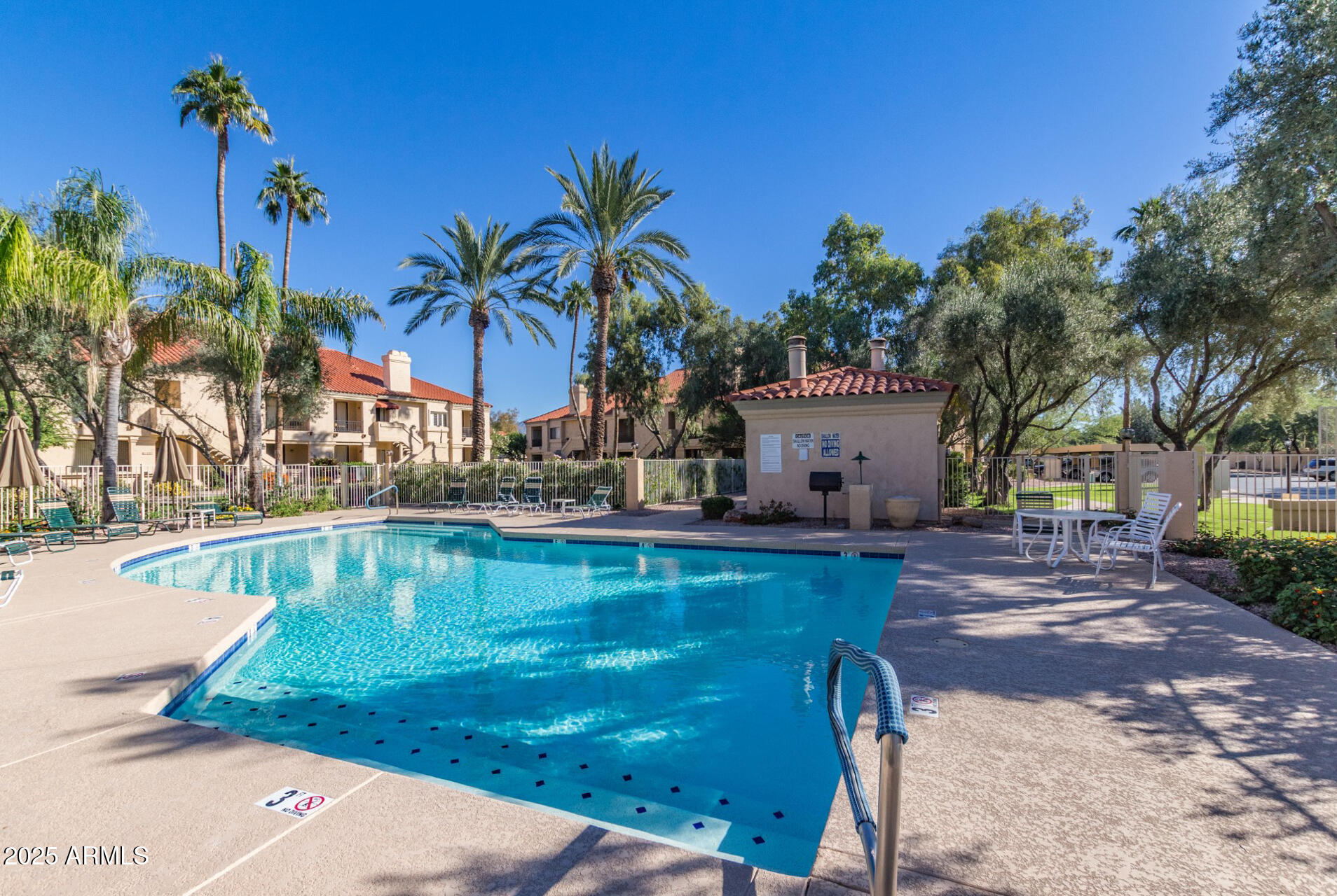 9711 East Mountain View Road, Unit 2524 Scottsdale, AZ 85258 - Photo 33 of 48 a view of a swimming pool with a garden