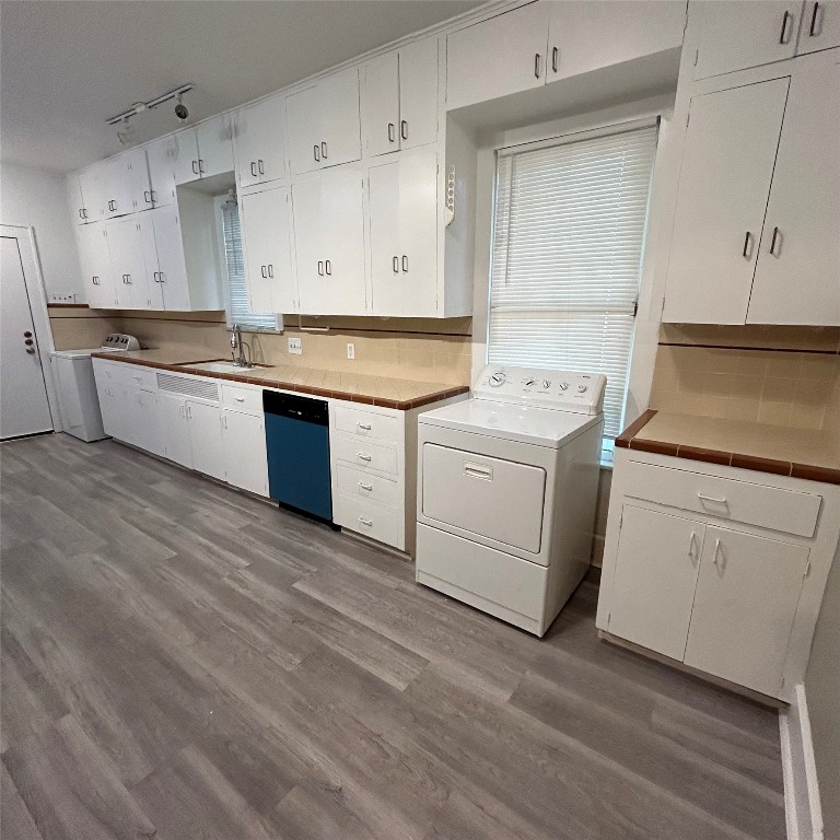 1115 West 22 1/2 Street Austin, TX 78705 - Photo 17 of 33 a kitchen with granite countertop white cabinets and white appliances