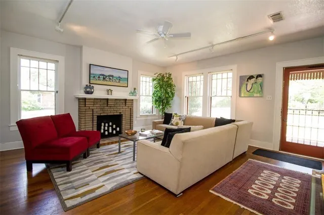 a living room with furniture fireplace and window